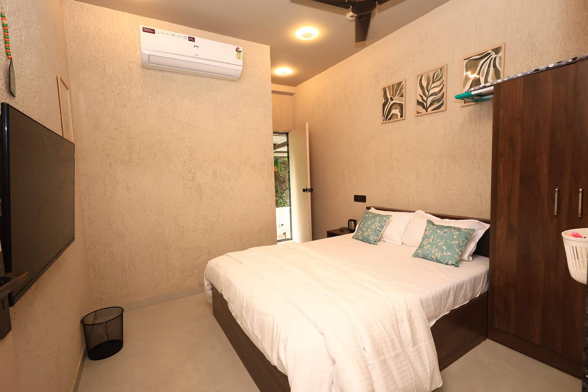 Hinata studio with a warm wood bed and soft aqua accents