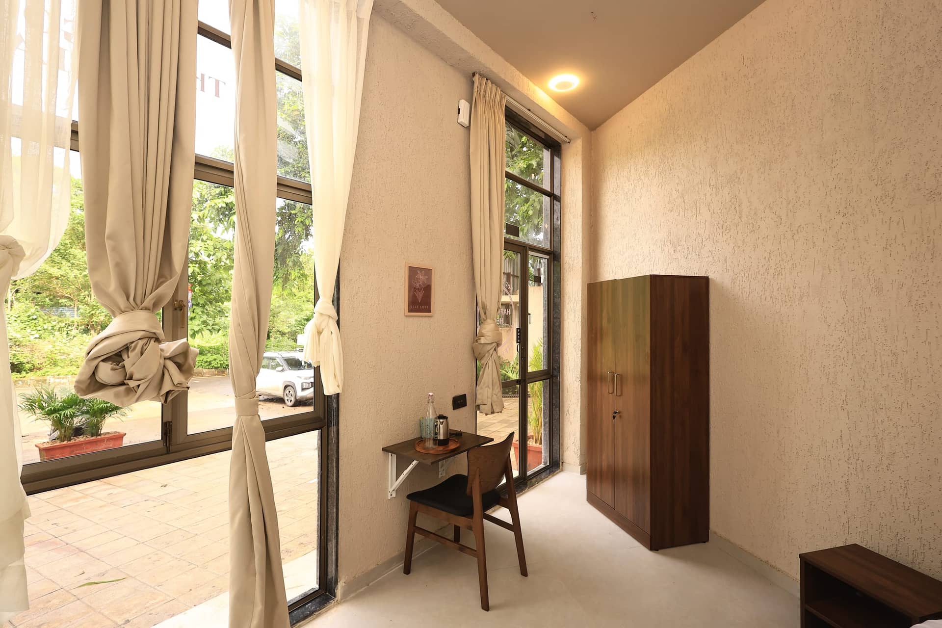 Raku studio filled with daylight from floor-to-ceiling garden windows
